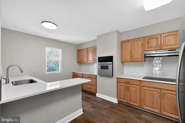 a kitchen with cabinets a sink and appliances