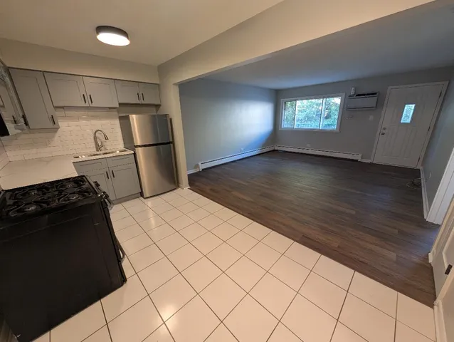 a kitchen with a refrigerator and a stove