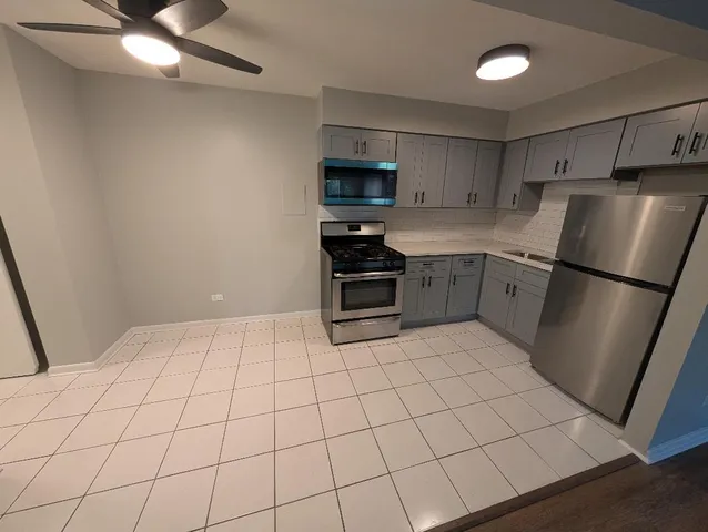 a kitchen with a stove a refrigerator and a sink