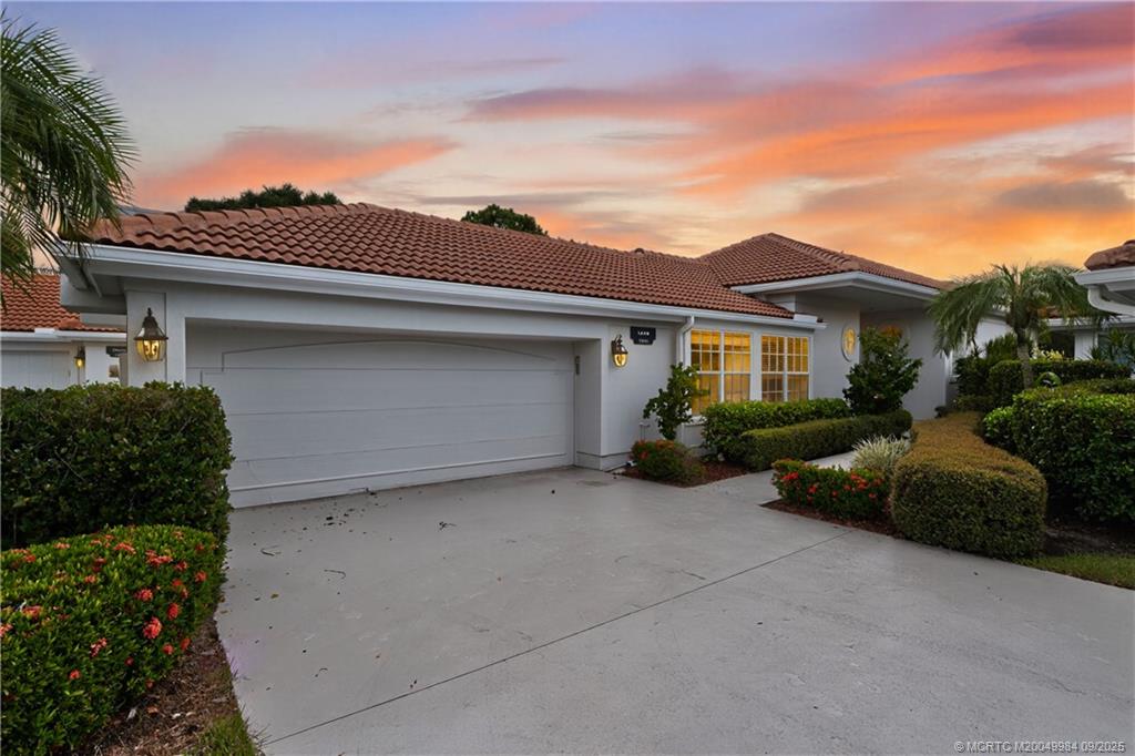 13005 Harbour Ridge Boulevard Palm City, FL 34990 - Photo 1 of 40 front view of a house with a yard
