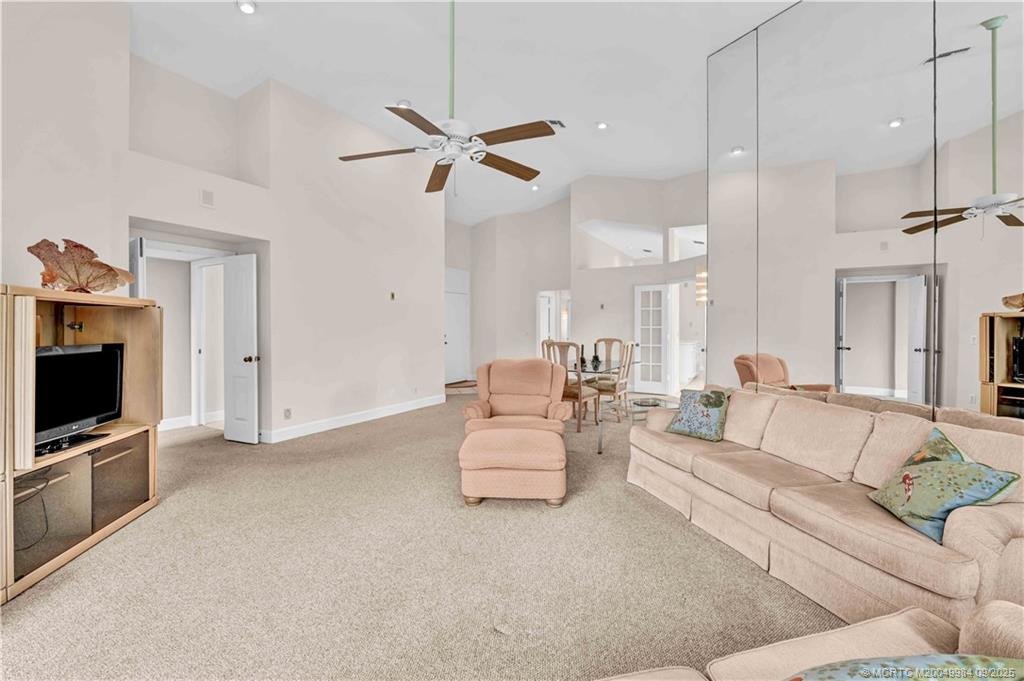 13005 Harbour Ridge Boulevard Palm City, FL 34990 - Photo 13 of 40 a living room with furniture and a flat screen tv