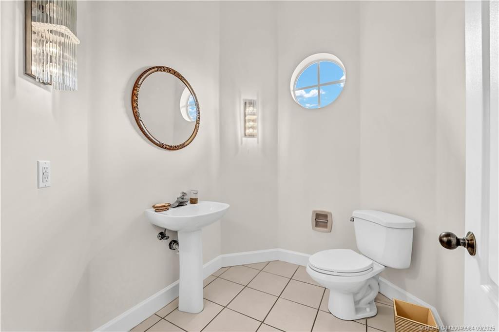 13005 Harbour Ridge Boulevard Palm City, FL 34990 - Photo 14 of 40 a bathroom with a sink mirror and toilet