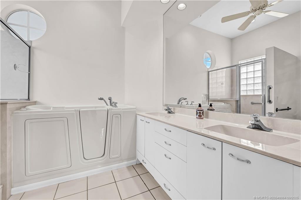 13005 Harbour Ridge Boulevard Palm City, FL 34990 - Photo 18 of 40 a bathroom with a sink and a mirror