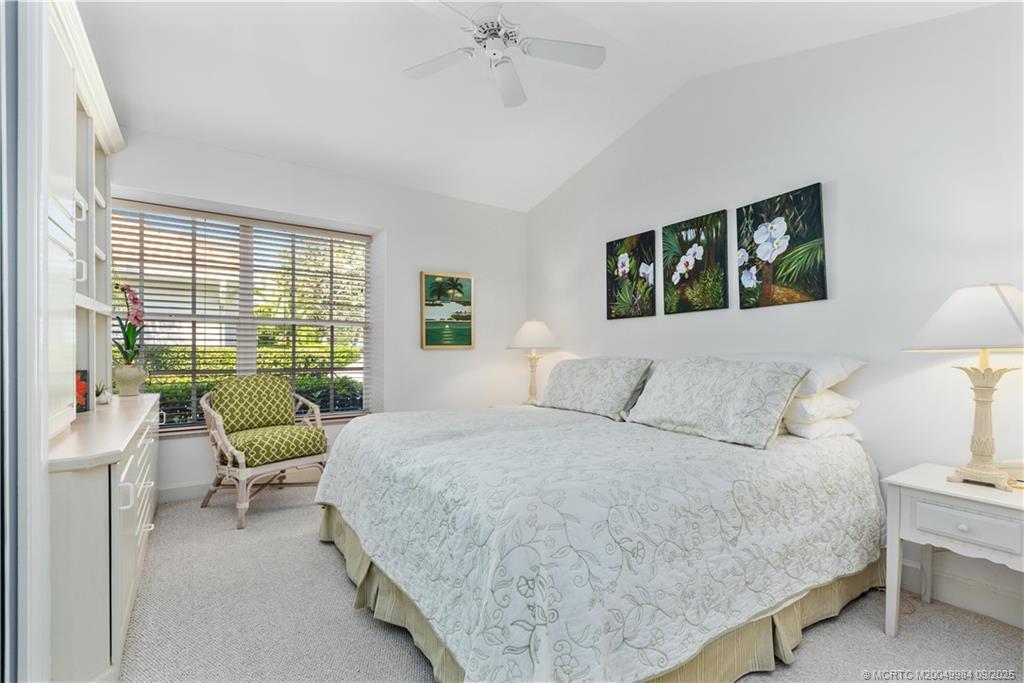 13005 Harbour Ridge Boulevard Palm City, FL 34990 - Photo 21 of 40 a bedroom with a bed and a large window