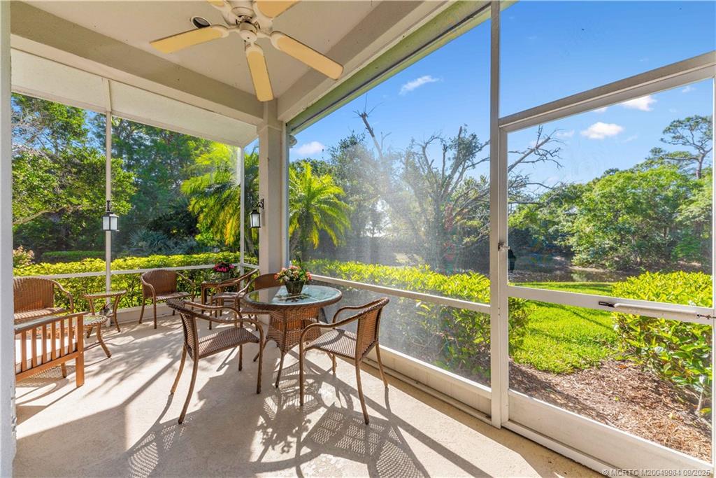 13005 Harbour Ridge Boulevard Palm City, FL 34990 - Photo 24 of 40 a view of a patio with table and chairs potted plants with wooden floor and fence