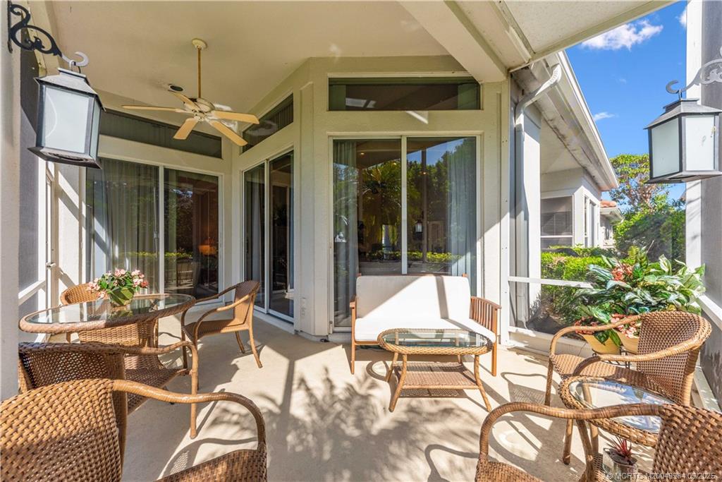 13005 Harbour Ridge Boulevard Palm City, FL 34990 - Photo 25 of 40 a view of a patio with couches chairs and potted plants