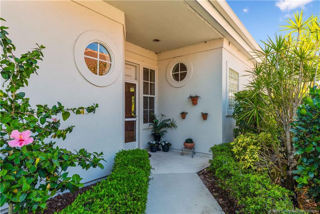 13005 Harbour Ridge Boulevard Palm City, FL 34990 - Photo 3 of 40 a front view of a house with garden