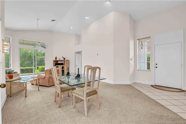 a living room with furniture a flat screen tv and a large window