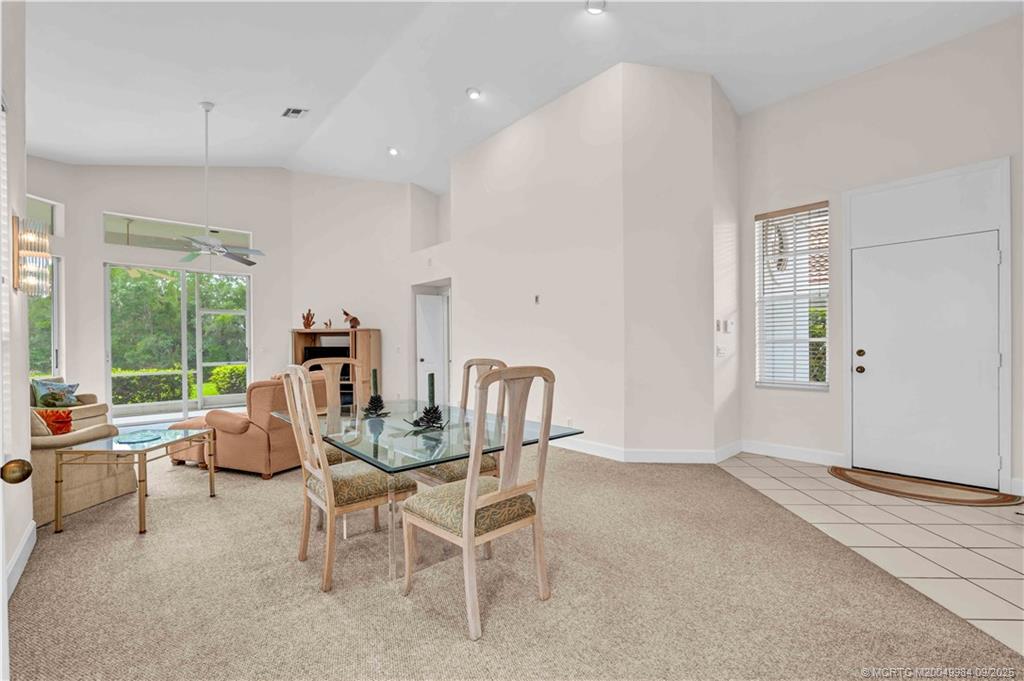 13005 Harbour Ridge Boulevard Palm City, FL 34990 - Photo 10 of 40 a dining room with furniture and large windows
