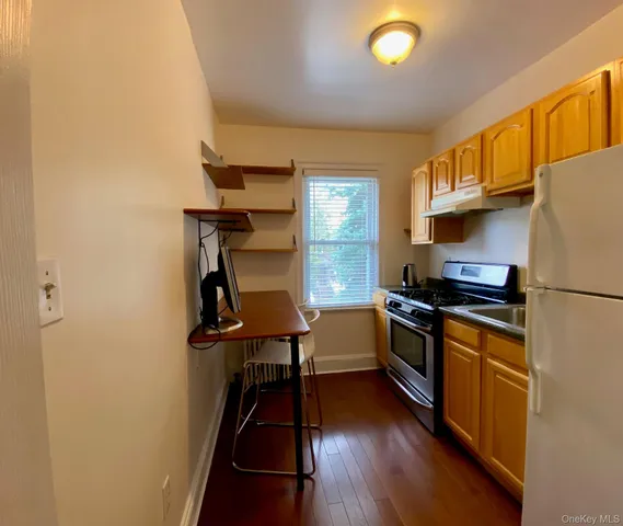 a kitchen with granite countertop a stove a sink dishwasher and a refrigerator