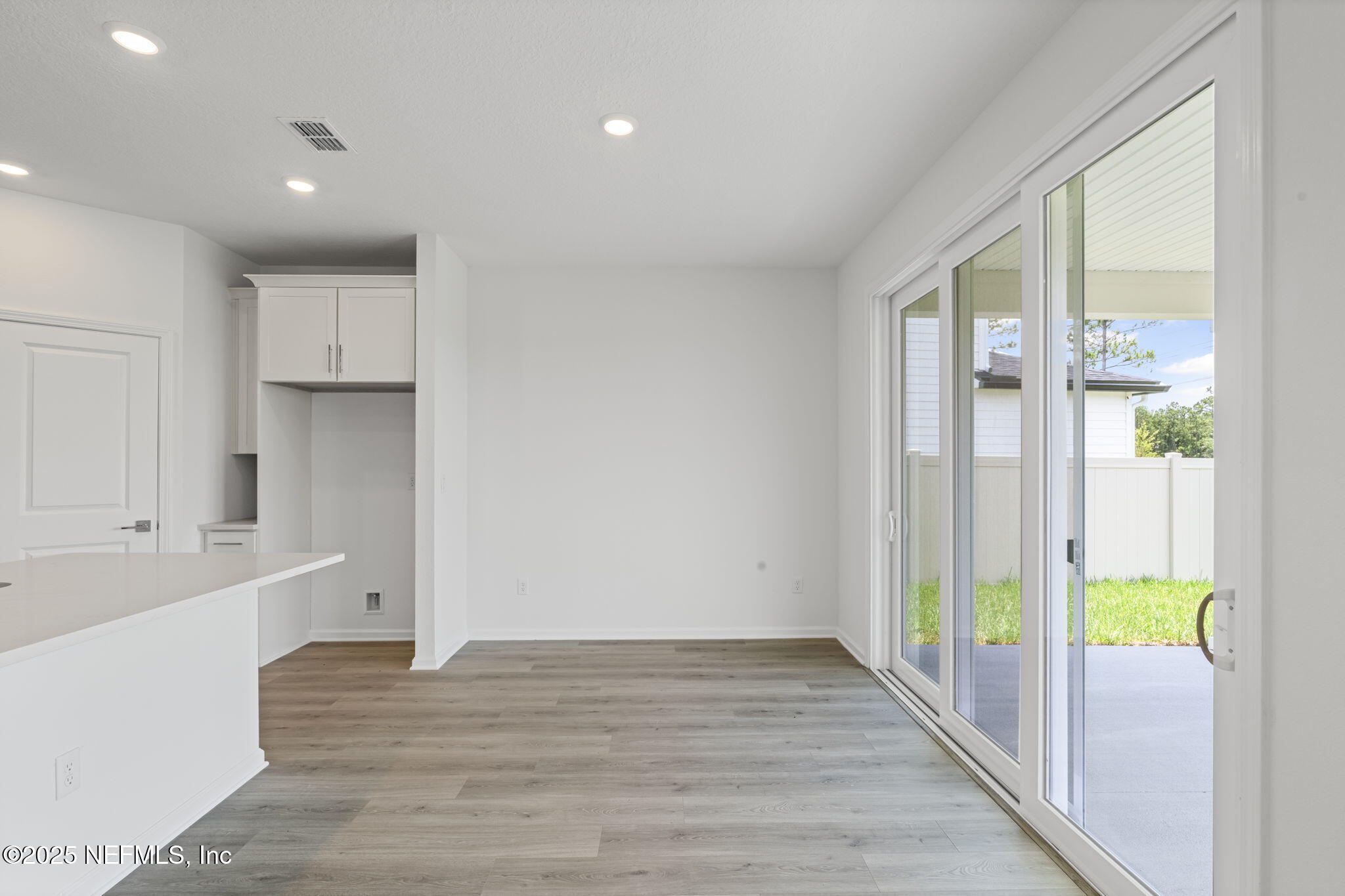 386 Whirlwind Place St. Augustine, FL 32095 - Photo 18 of 41 a view of hallway with wooden floor and natural light