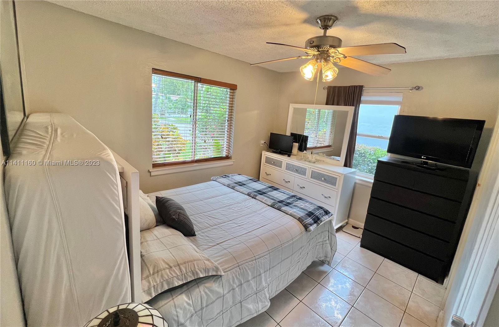 342 Southwest 29th Road Miami, FL 33129 - Photo 13 of 28 a bedroom with a bed and a flat screen tv
