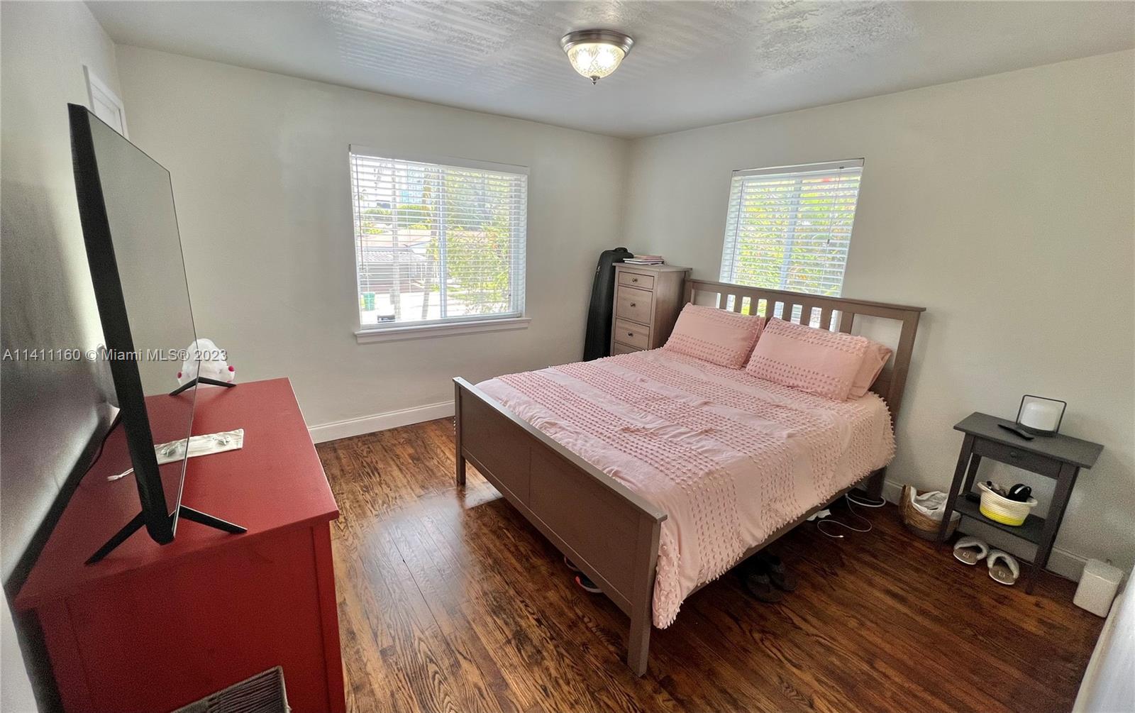 342 Southwest 29th Road Miami, FL 33129 - Photo 20 of 28 a bedroom with a bed and wooden floor