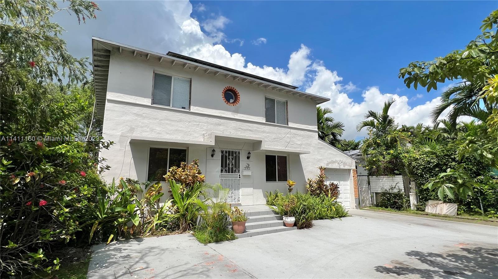 342 Southwest 29th Road Miami, FL 33129 - Photo 2 of 28 a front view of a house with potted plants