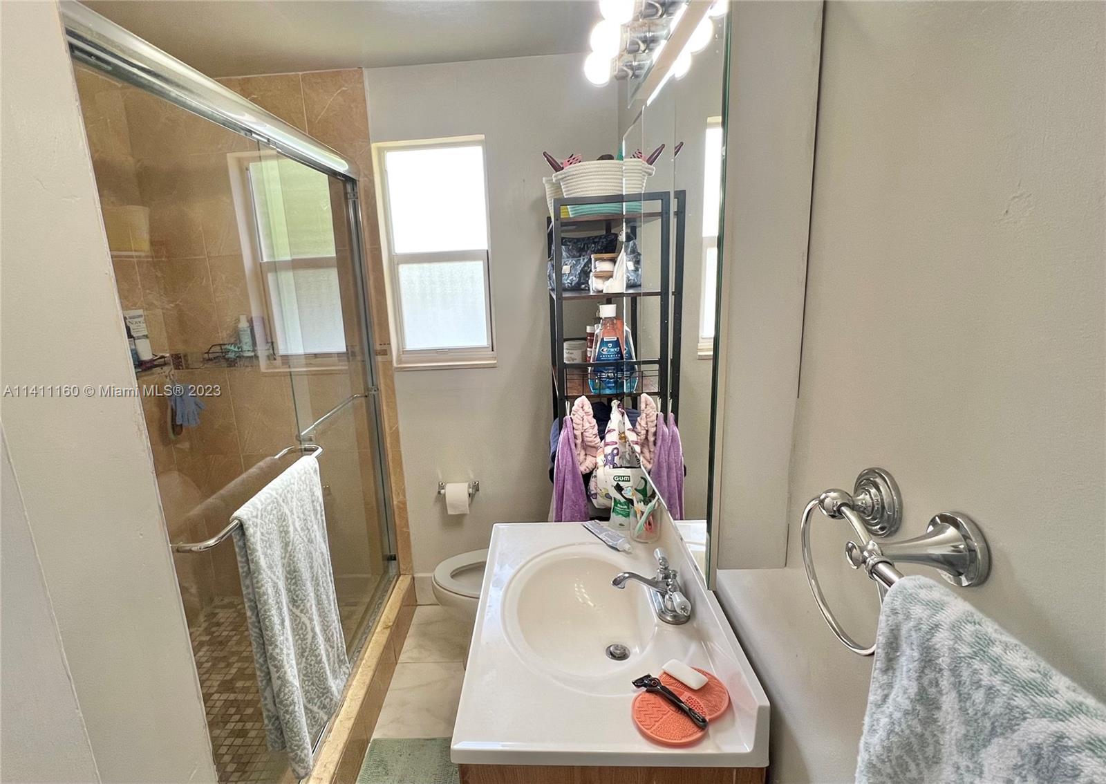 342 Southwest 29th Road Miami, FL 33129 - Photo 21 of 28 a bathroom with a tub sink and mirror