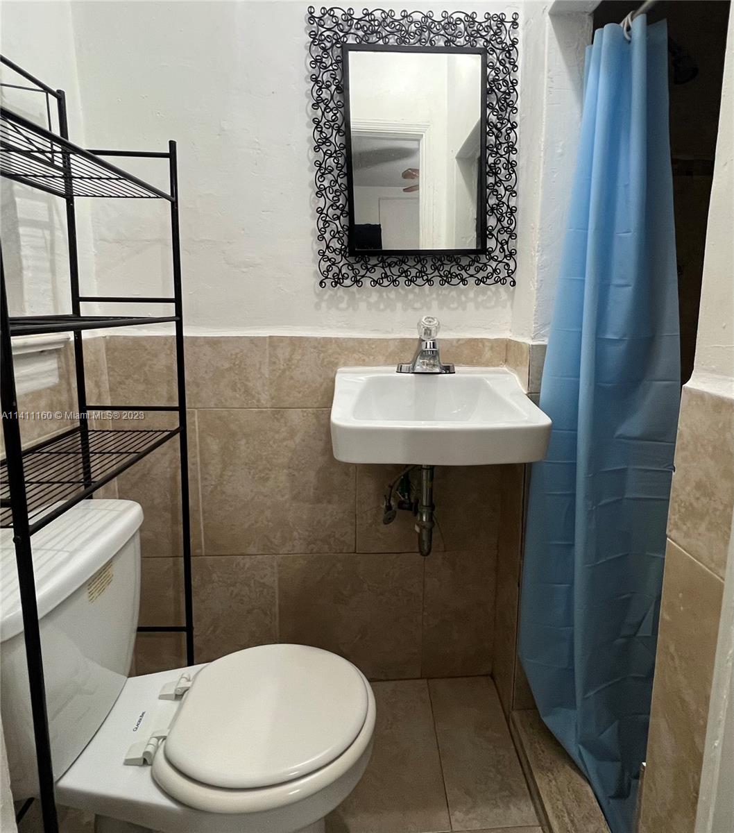 342 Southwest 29th Road Miami, FL 33129 - Photo 24 of 28 a bathroom with a toilet sink and mirror