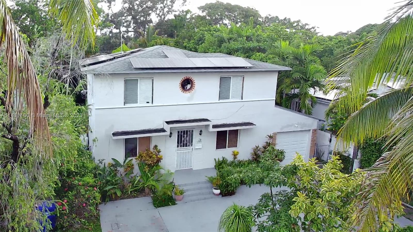 342 Southwest 29th Road Miami, FL 33129 - Photo 3 of 28 a aerial view of a house with a yard and potted plants