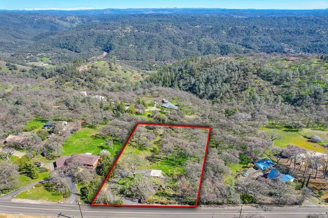 a view of a yard with wooden fence