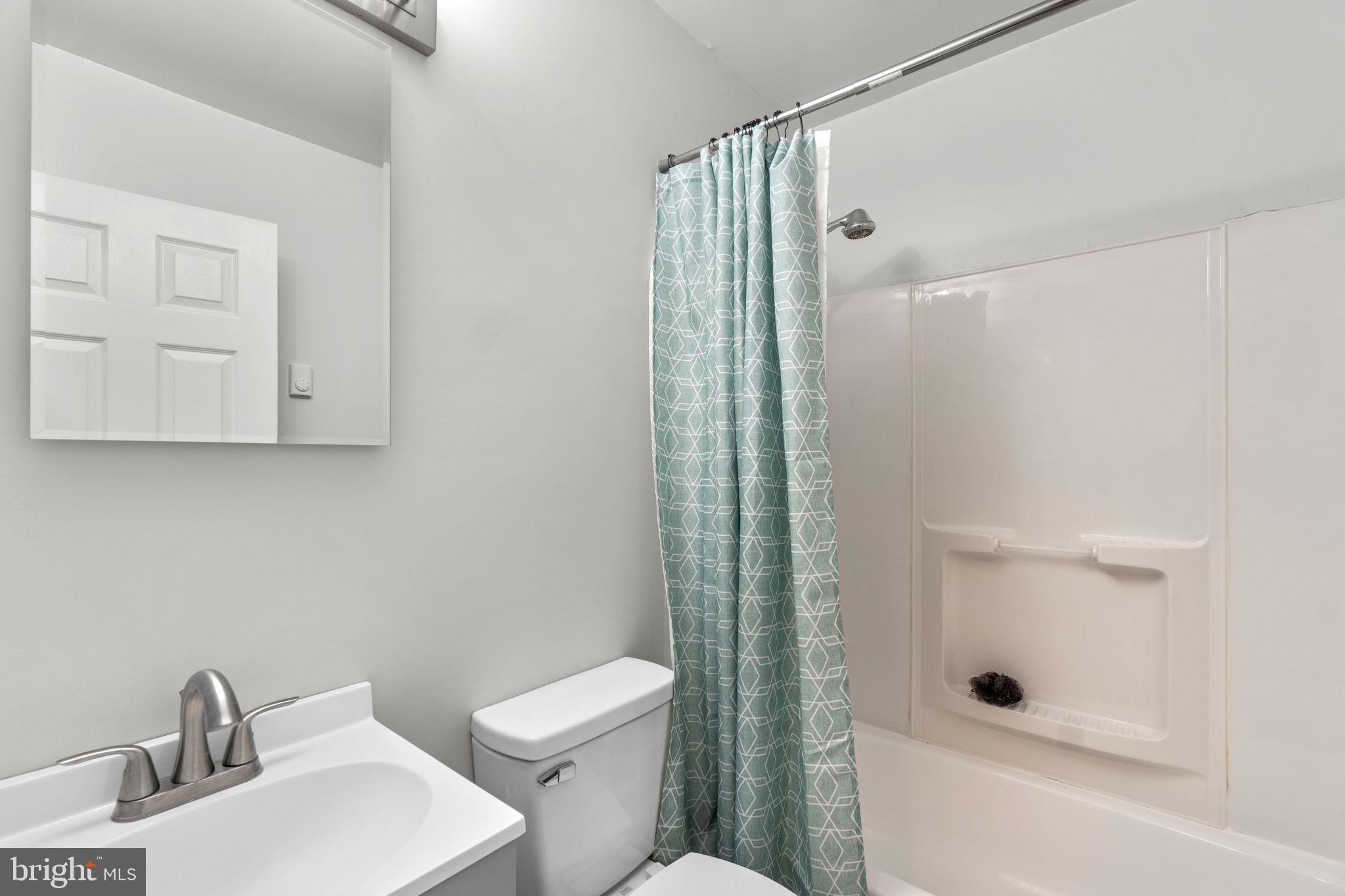 313 Janice Way Westminster, MD 21158 - Photo 14 of 23 a bathroom with a toilet a sink and shower