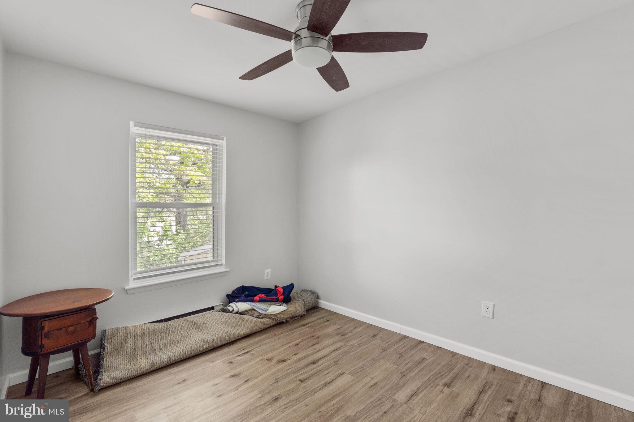 313 Janice Way Westminster, MD 21158 - Photo 15 of 23 an empty room with wooden floor and windows