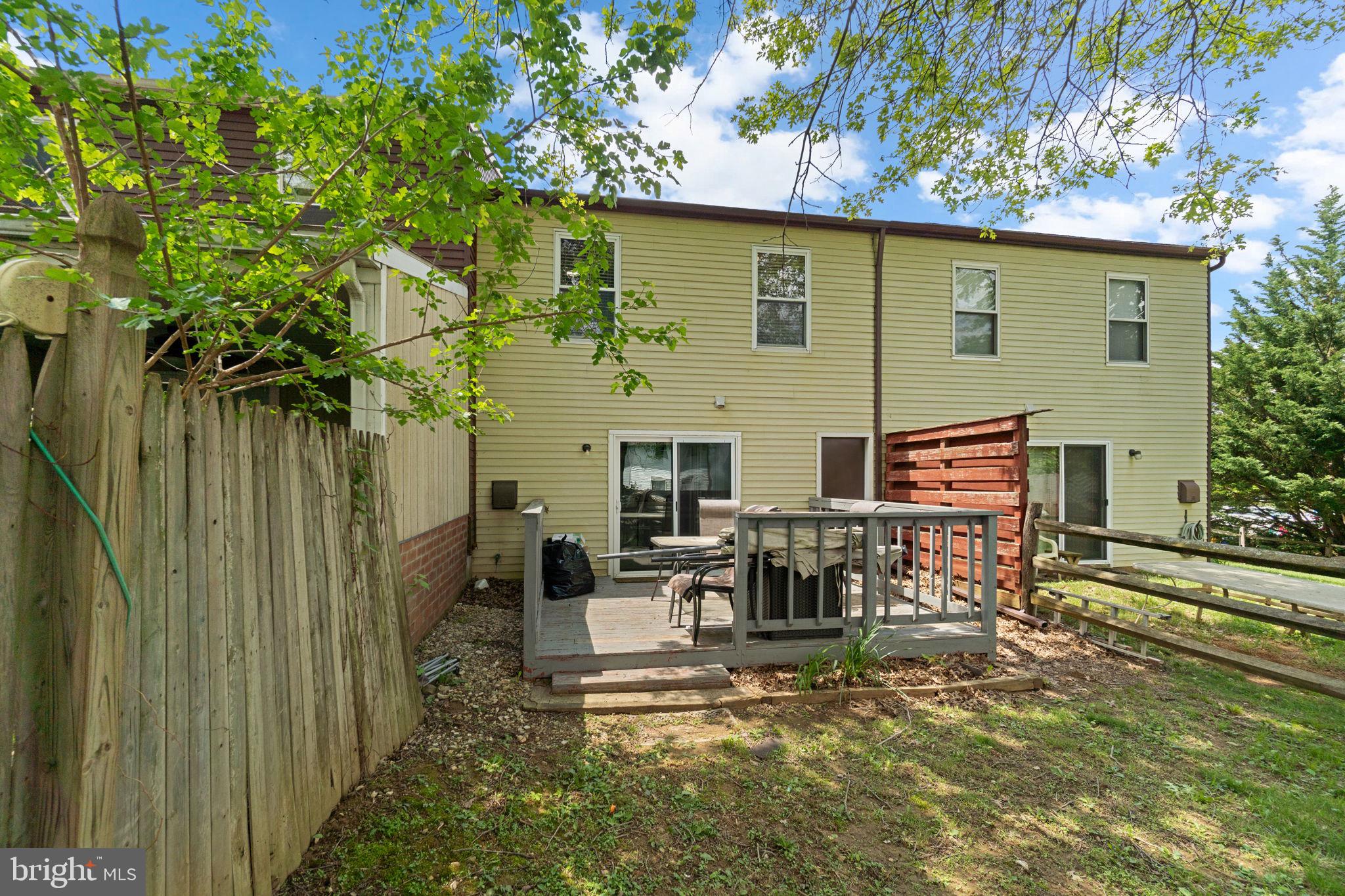 313 Janice Way Westminster, MD 21158 - Photo 20 of 23 a view of a patio with table and chairs with wooden floor and fence