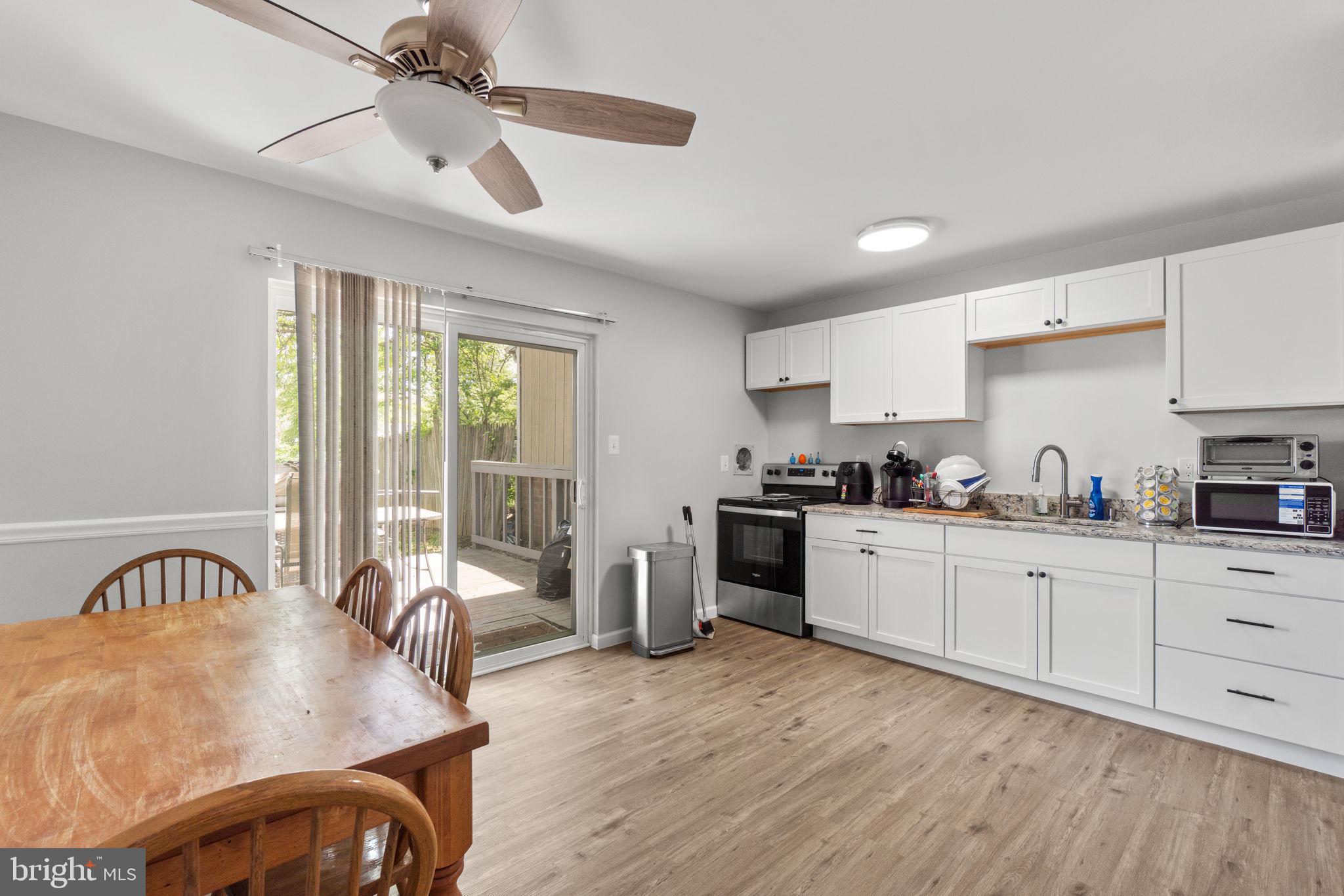 313 Janice Way Westminster, MD 21158 - Photo 9 of 23 a kitchen with stainless steel appliances granite countertop a stove a sink dishwasher a refrigerator with white cabinets and wooden floor
