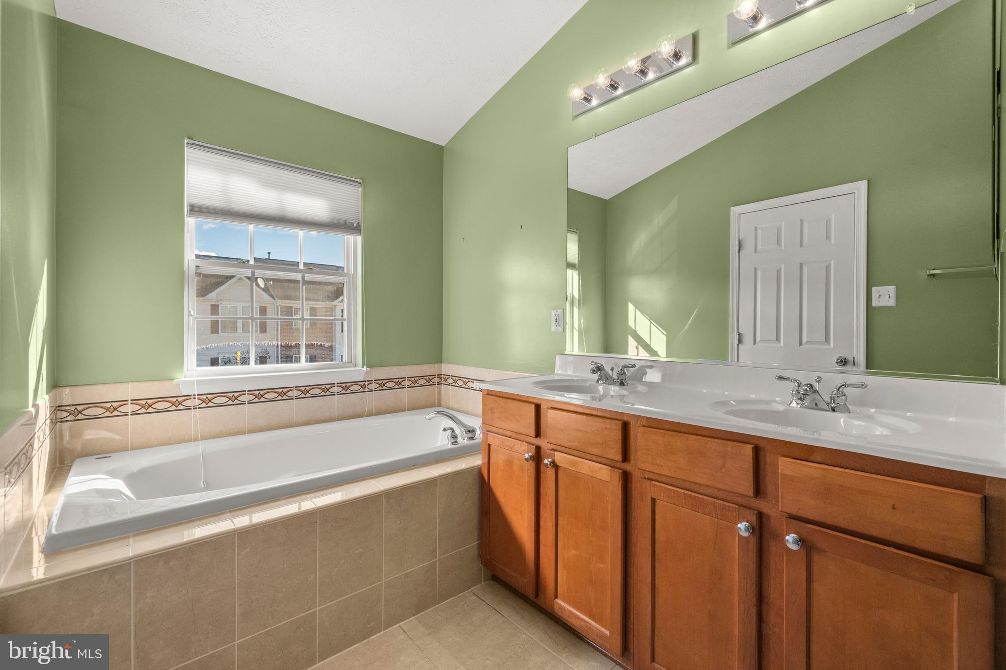 826 Lowe Road Baltimore, MD 21220 - Photo 12 of 35 a spacious bathroom with a granite countertop tub sink and mirror