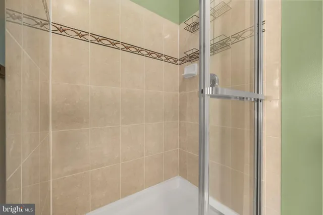 a bathroom with a glass shower door