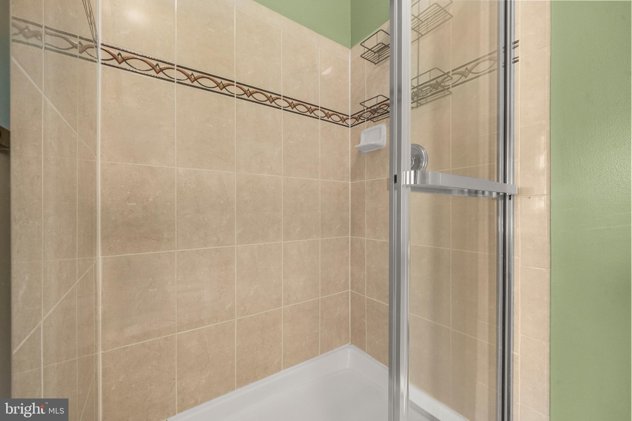 826 Lowe Road Baltimore, MD 21220 - Photo 13 of 35 a bathroom with a glass shower door