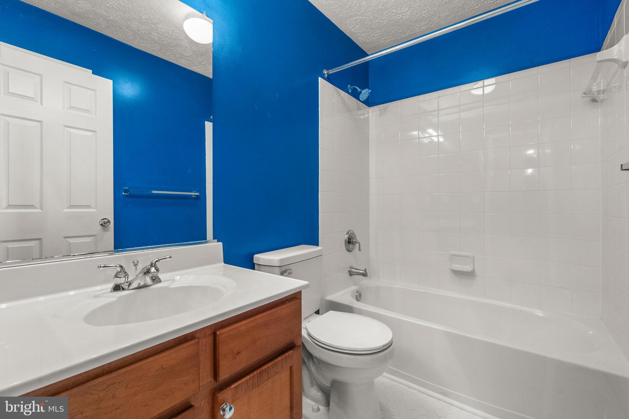 826 Lowe Road Baltimore, MD 21220 - Photo 19 of 35 a bathroom with a sink a toilet and shower