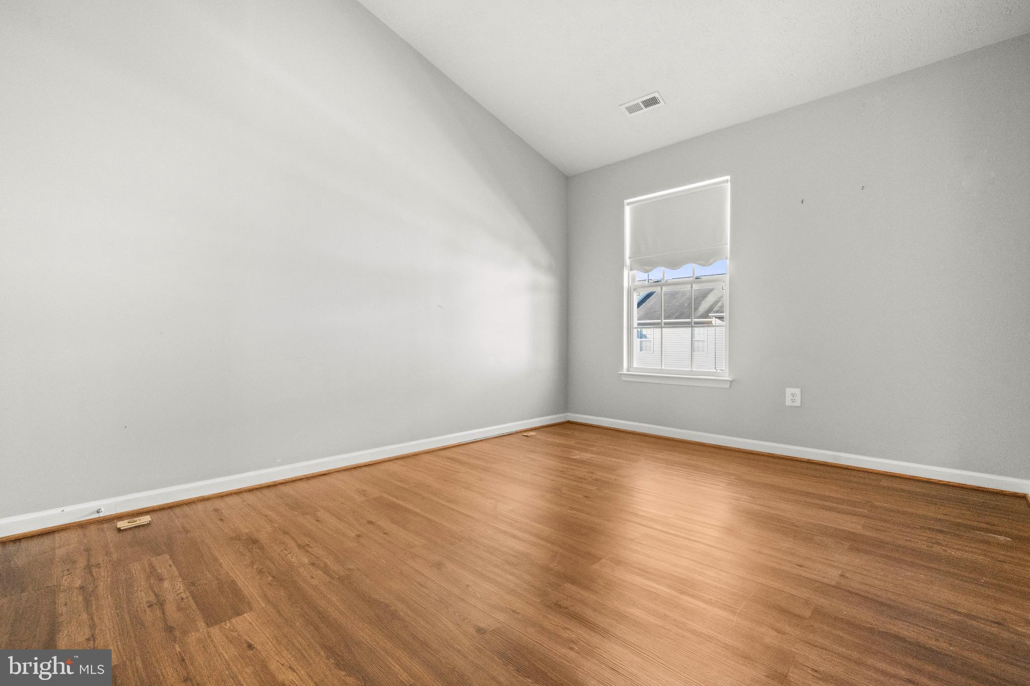826 Lowe Road Baltimore, MD 21220 - Photo 20 of 35 a view of an empty room with wooden floor and a window