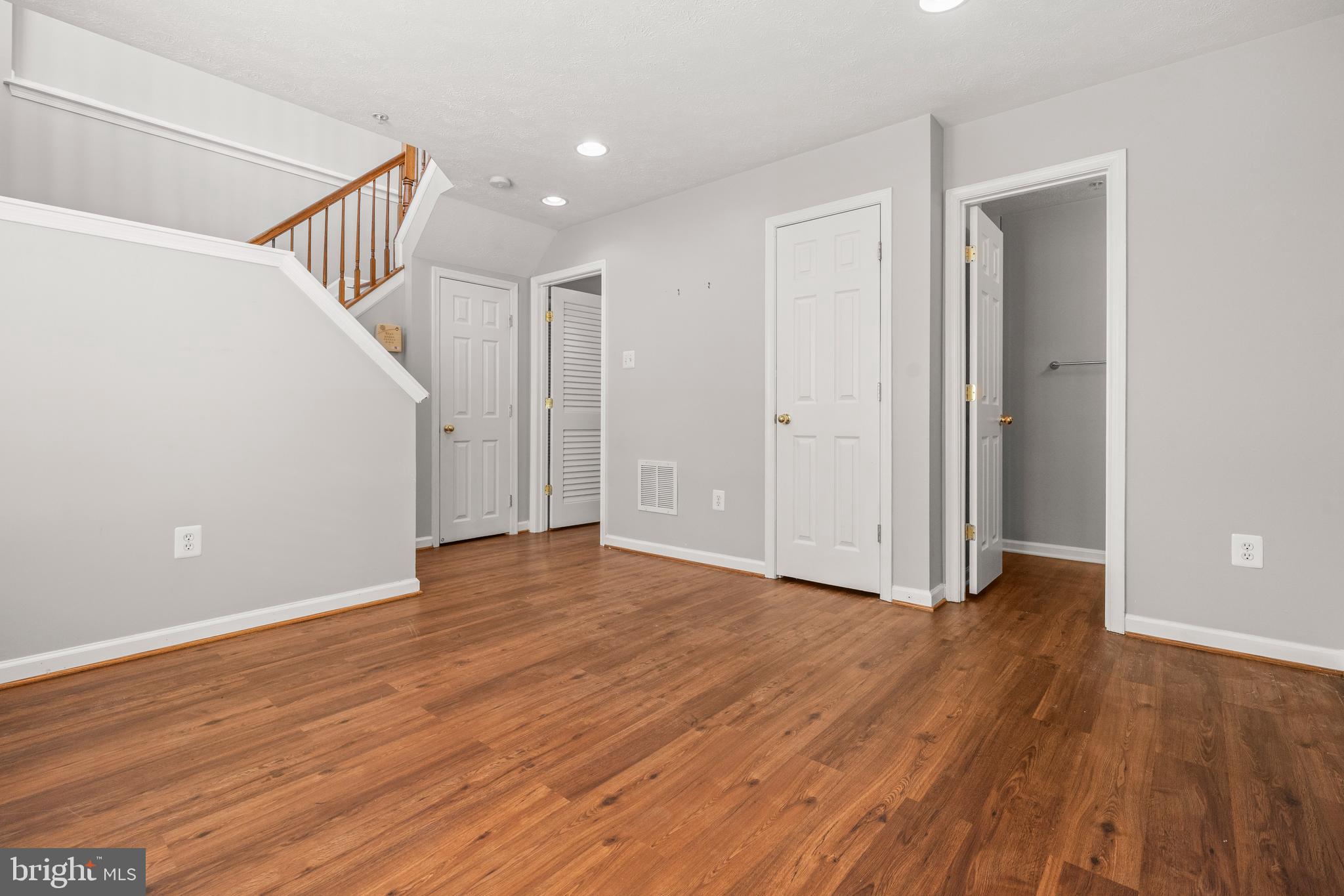826 Lowe Road Baltimore, MD 21220 - Photo 22 of 35 a view of an empty room with wooden floor and stairs
