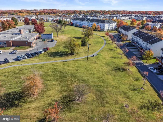 a view of a swimming pool with lawn chairs and a yard