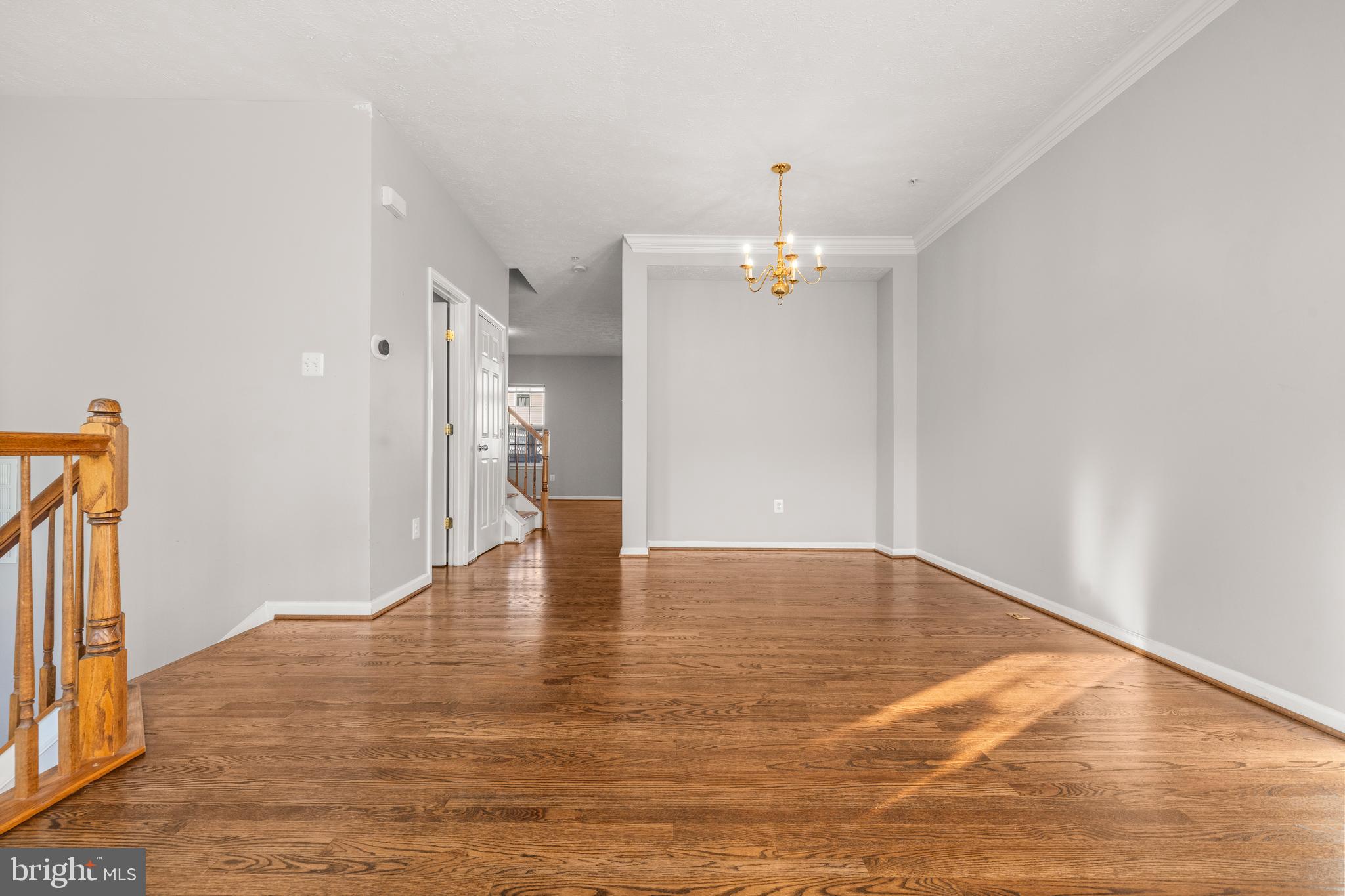 826 Lowe Road Baltimore, MD 21220 - Photo 5 of 35 a view of an empty room with wooden floor and a window