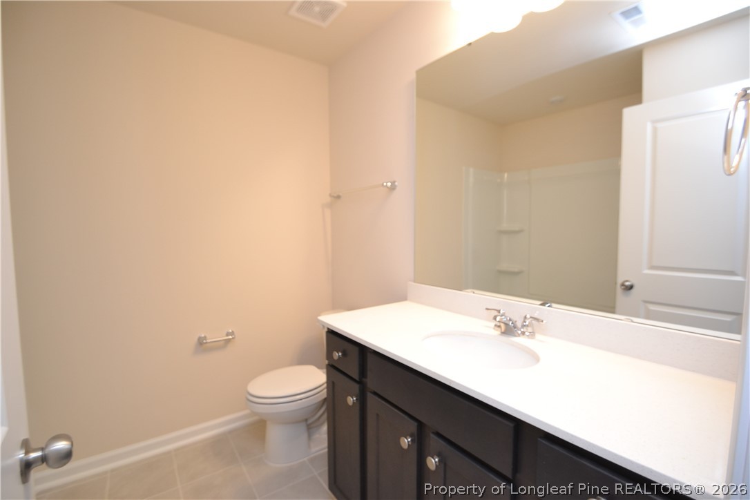 5703 Preveza Place Raleigh, NC 27603 - Photo 15 of 33 a bathroom with a sink a toilet and mirror