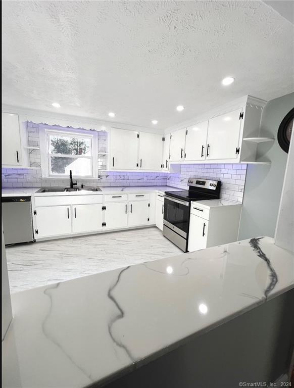a kitchen with stainless steel appliances a sink and a stove
