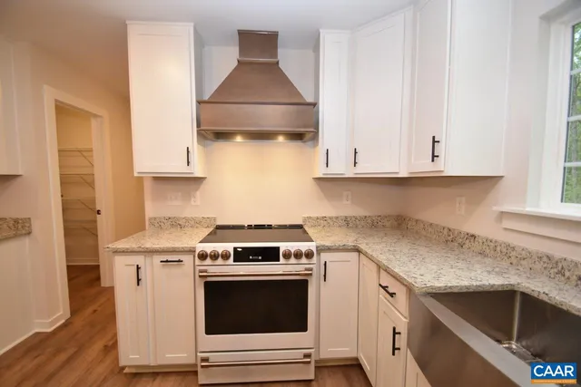 a kitchen with a stove and a sink