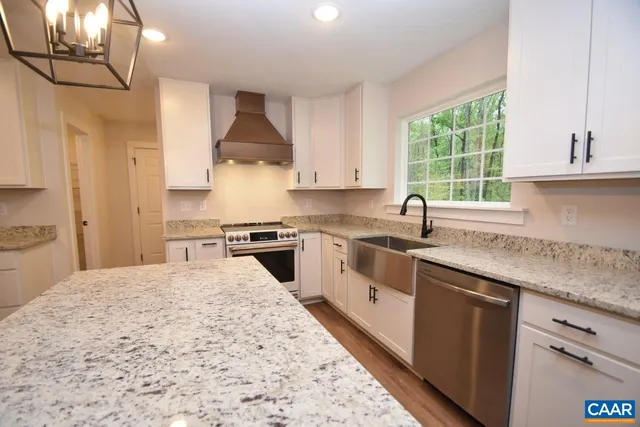 a kitchen with a stove a sink and a refrigerator