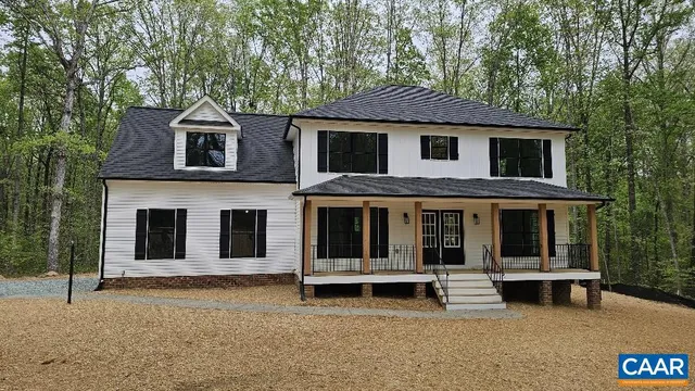 a view of a house with a large window and a large tree