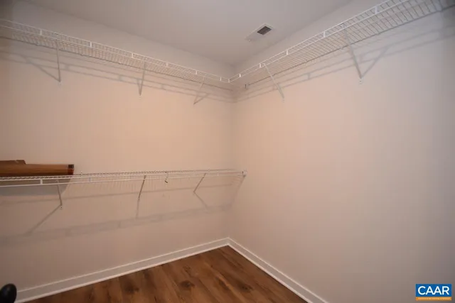 a view of a room with wooden floor and cabinet