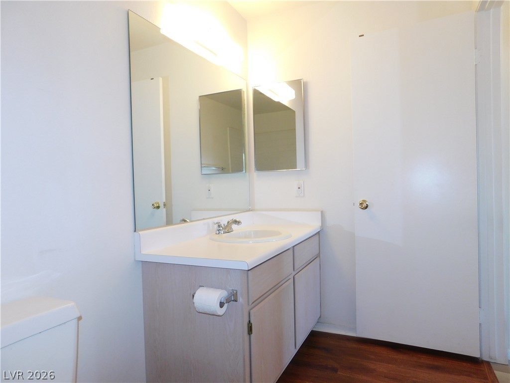 5221 South Lindell Road, Unit 202 Las Vegas, NV 89118 - Photo 26 of 28 A well-appointed bathroom with a vanity and wood-look flooring awaits.