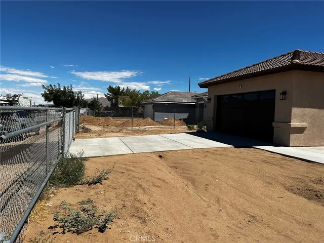 a large hall with stainless steel appliances granite countertop a large counter top a stove and a refrigerator