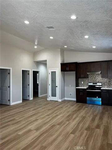a large kitchen with granite countertop stainless steel appliances and a sink