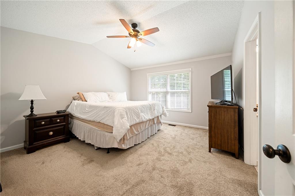 921 Pace Road Hiram, GA 30141 - Photo 18 of 41 a bedroom with a bed and a chandelier