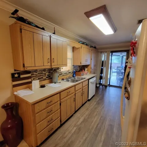 a kitchen with a sink appliances and cabinets