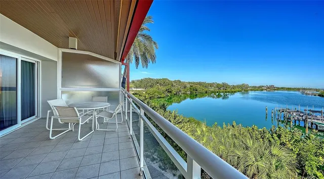 a balcony with table and chairs