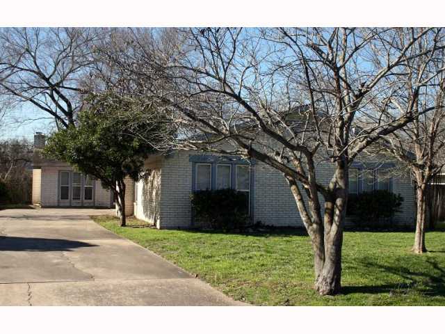2107 Pompton Drive, Unit B Austin, TX 78757 - Photo 1 of 1 a tree in front of a white house