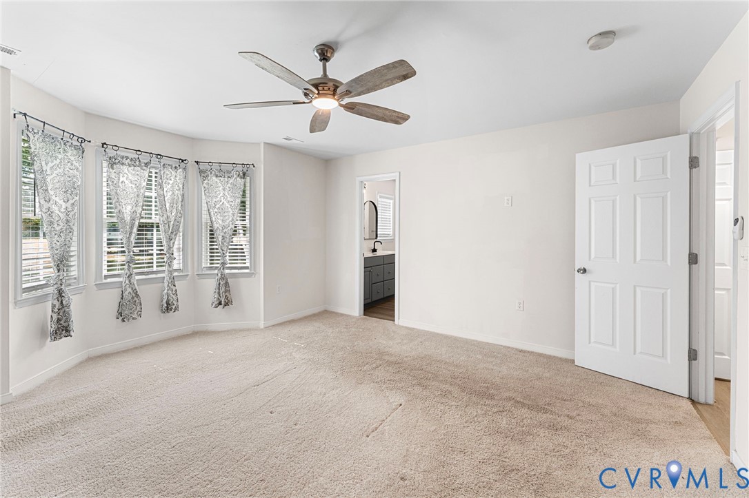 1146 Indian Valley Road Heathsville, VA 22473 - Photo 29 of 45 an empty room with chandelier fan and windows
