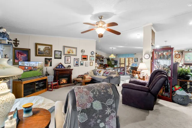 a living room with fireplace furniture and a flat screen tv