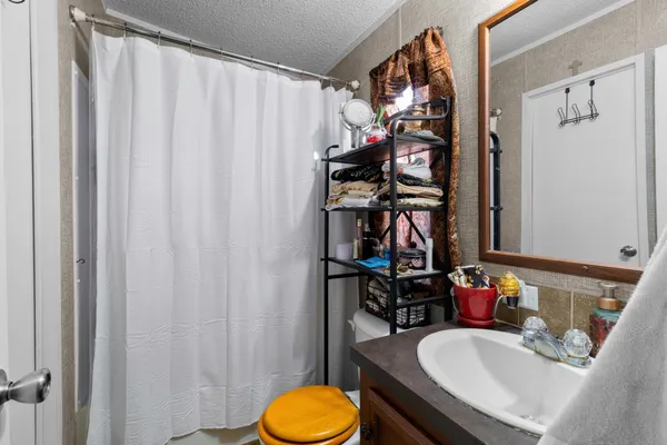 a view of a bathroom with a sink and a mirror